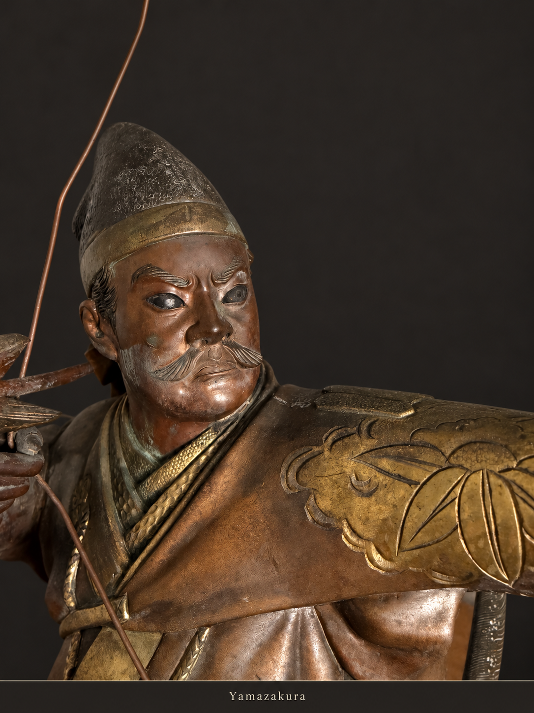 Close-up of bronze archer face and gilt shoulder decoration; Yamazakura styled presentation