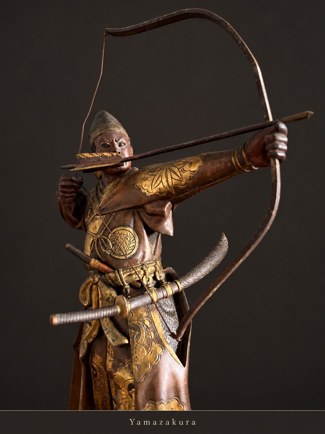 Close view of bronze archer, bow and gilt costume; Yamazakura styled presentation