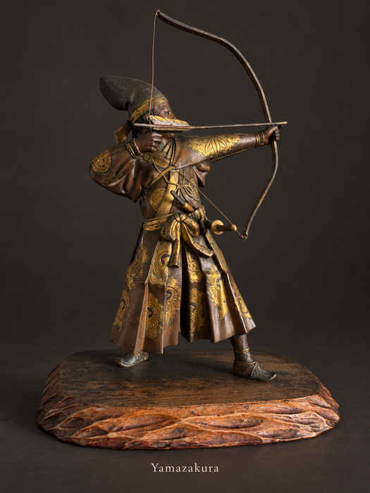 Japanese bronze archer with gilt decoration on carved wooden stand; Yamazakura styled presentation